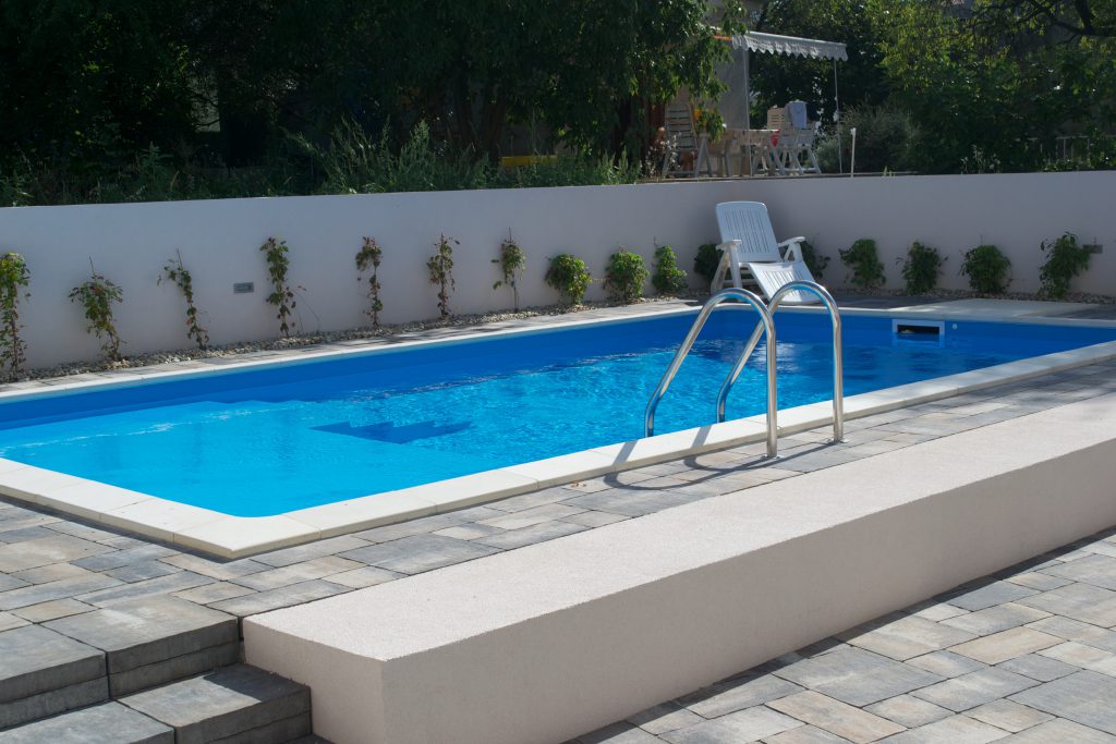 Relax by the pool in the back yard.